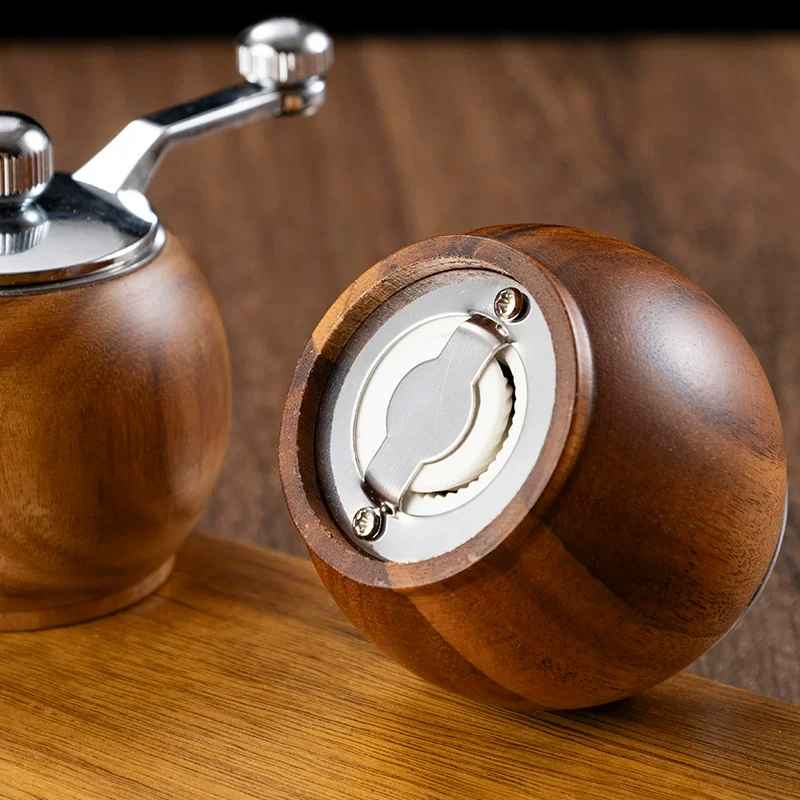 Hand-operated wooden pepper mill for kitchen use